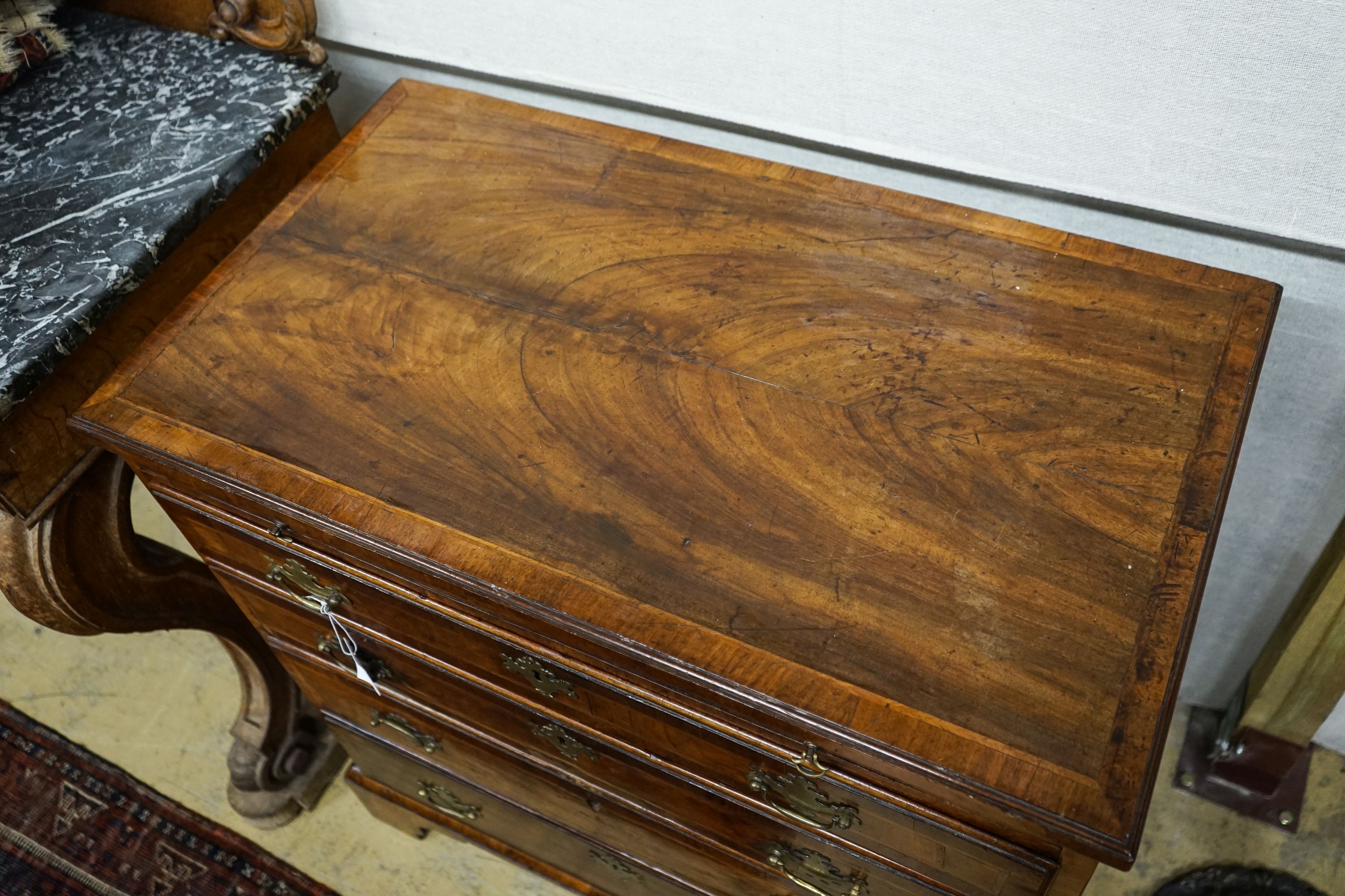 An 18th century and later feather banded walnut chest with slide, width 84cm, depth 49cm, height 86cm